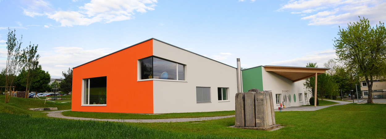 Kindergarten, Holzbau, orange grau grüne Fassade